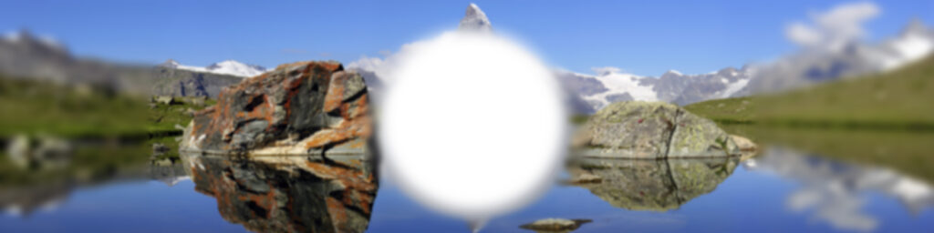 Das Bild zeigt das Panorama des Matterhorn mit einem unscharfen weissen Fleck in der Mitte. 